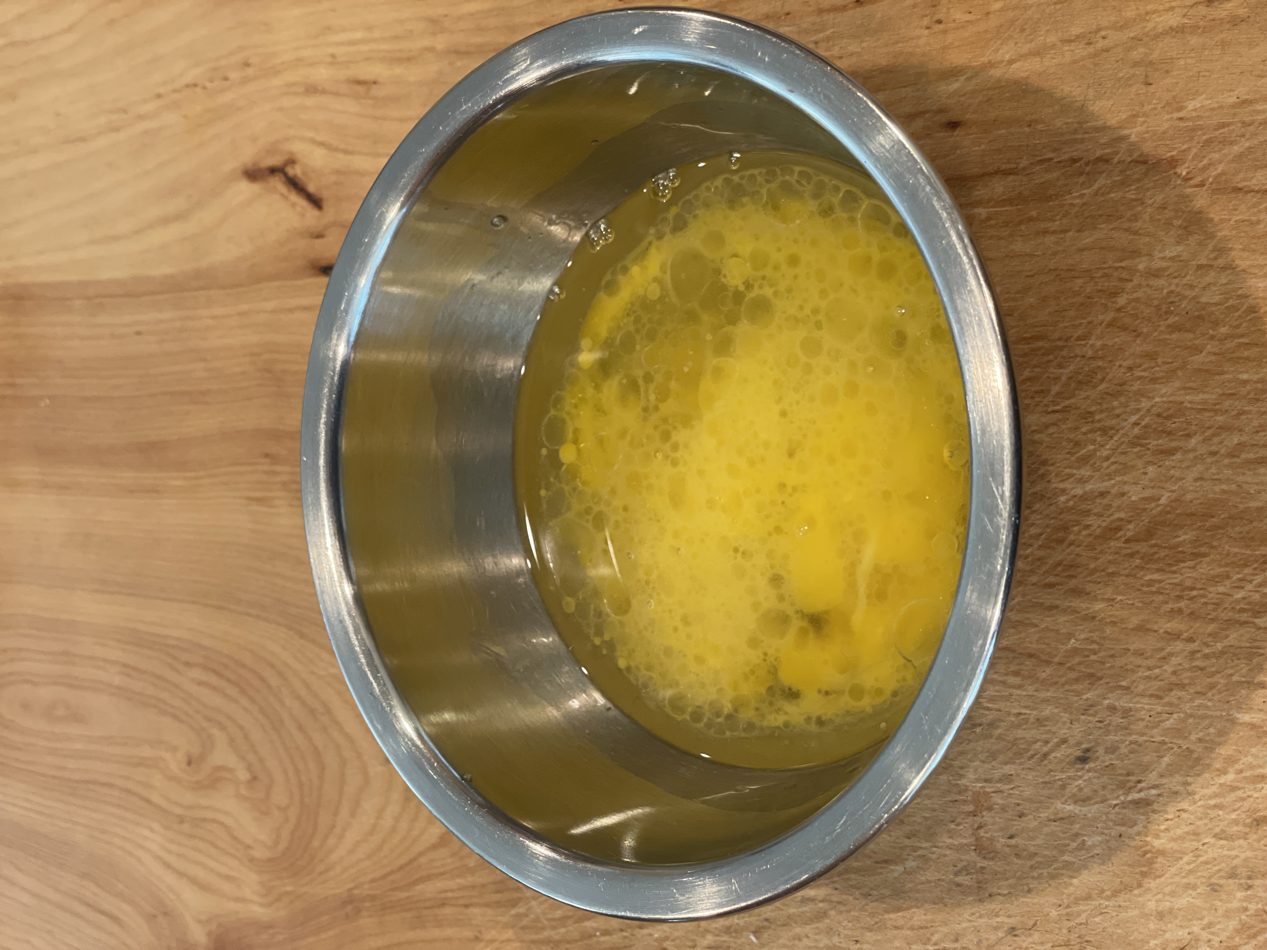 Eggs and oil mixed in a bowl